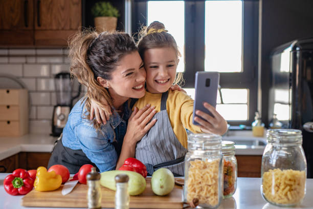 istock Mother and daughter having fun and preparing lunch in the kitchen 1282343752