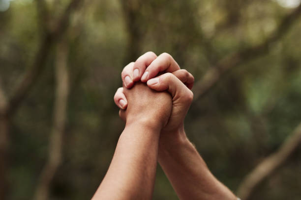 With unity comes victory Cropped shot of two women holding hands out in nature clingy girlfriend stock pictures, royalty-free photos & images