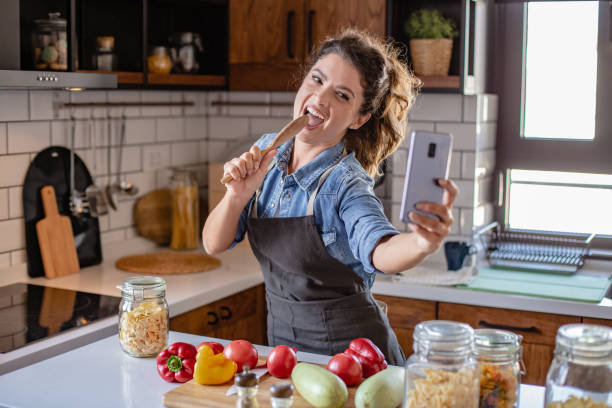istock Young woman having fun in the kitchen 1282345100