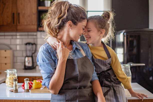 istock Mother and daughter having fun and preparing lunch in the kitchen 1282345138