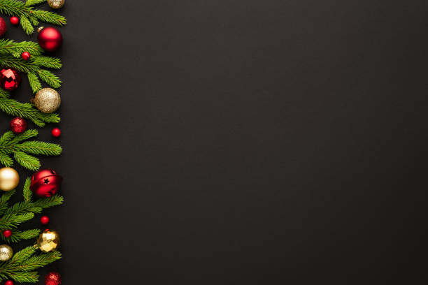 istock Frame of Christmas tree ornaments on a black background 1282345972