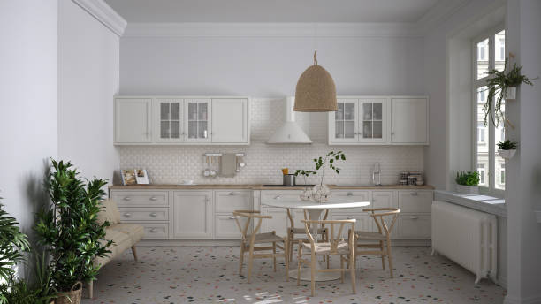 istock Retro white vintage kitchen with terrazzo marble floor and panoramic windows, dining room, round table with wooden chairs, potted plants, radiators, pendant lamp, cozy interior design 1282346372