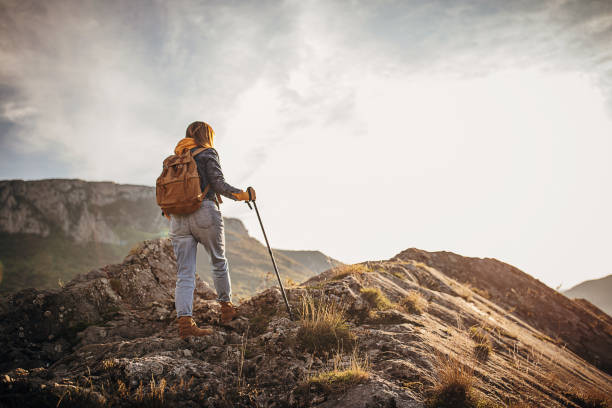 istock One woman with backpack hiking in the mountains 1282346596