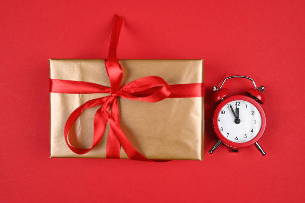 istock red watch and gift wrap on a red background 1282347760