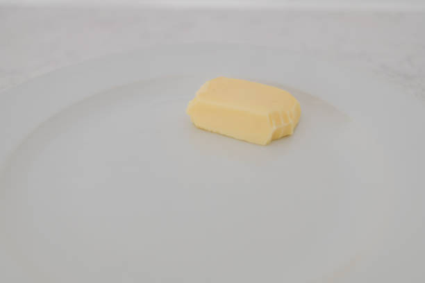 istock butter with a bite taken out on white plate 1282348280