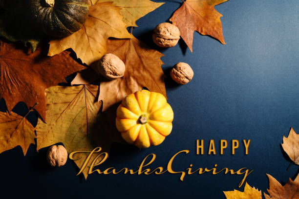 istock Happy Thanksgiving Day with maple leaves, nut and pumpkin on blu 1282349409
