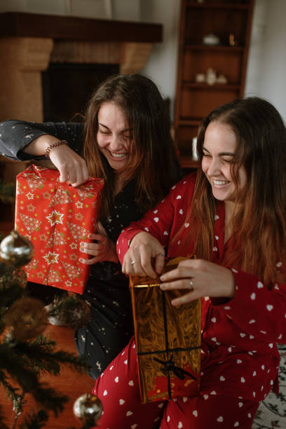 istock Young twin sisters opening christmas presents 1282349731