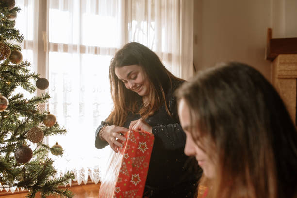 istock Young twin sisters opening christmas presents 1282350081