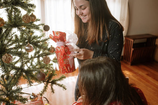 istock Young woman opening christmas presents 1282350243