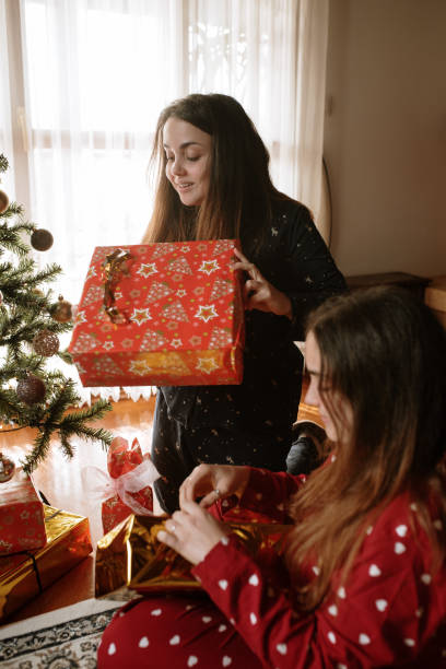 istock Young twin sisters opening christmas presents 1282350248