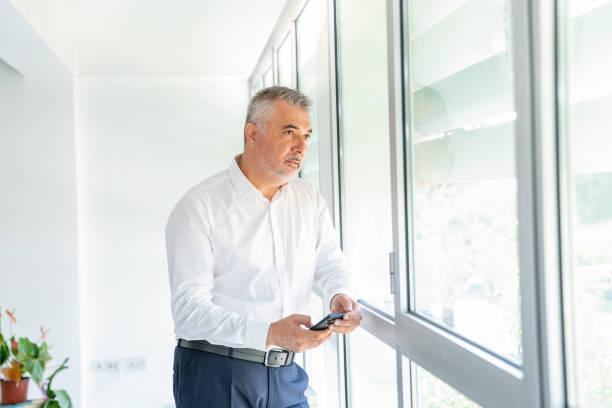 istock Businessman in office talking on phone 1282350361