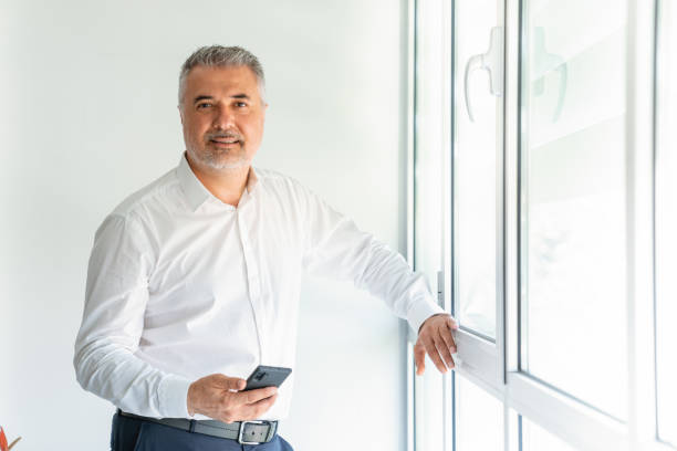 istock Businessman in office talking on phone 1282350414