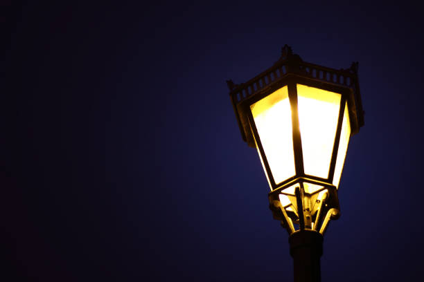 istock Abstract creative background with blurry bright yellow light from a luminous lantern against a dark blue sky 1282350746