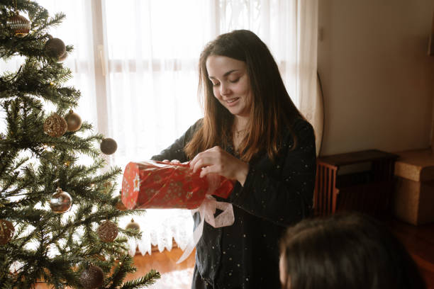 istock Young woman opening christmas presents 1282350820