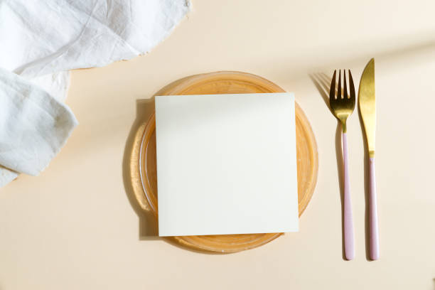 istock Dinner wooden board served fork, knife with paper card. 1282351677