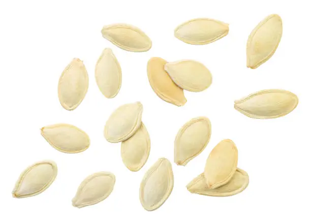 Pumpkin seeds falling close-up on a white background, isolated. Levitating Pumpkin Seeds