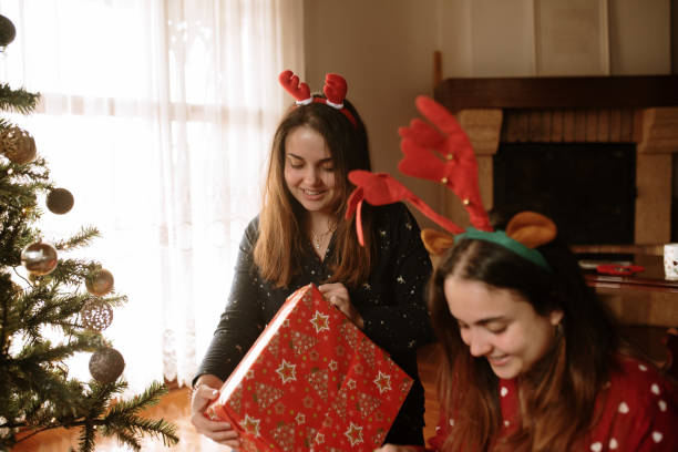 istock Young twin sisters opening christmas presents 1282352157