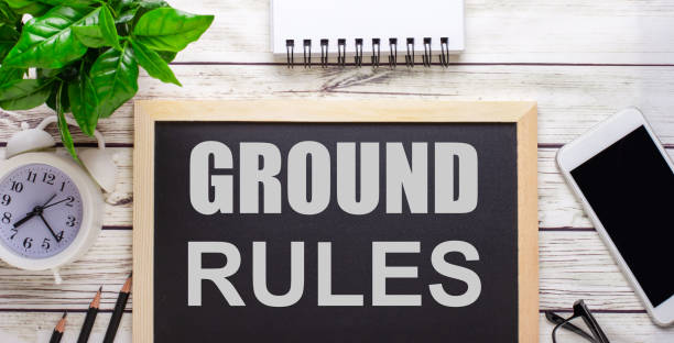 The word GROUND RULES written on a black background near pencils, a smartphone, a white notepad and a green plant in a pot The word GROUND RULES written on a black background near pencils, a smartphone, a white notepad and a green plant in a pot rules photos stock pictures, royalty-free photos & images