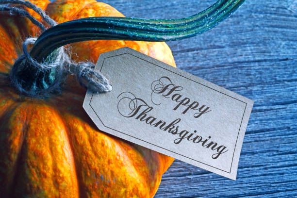 istock Happy Thanksgiving Tag Hanging From Pumpkin 1282353034