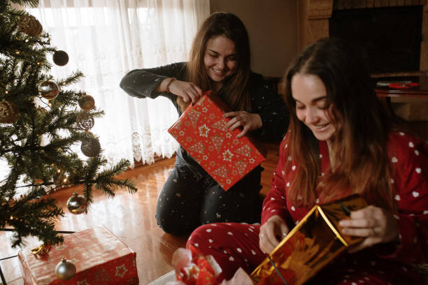 istock Young twin sisters opening christmas presents 1282353266
