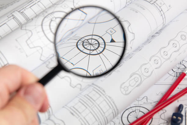 istock View of engineering drawings through a magnifying glass 1282353503