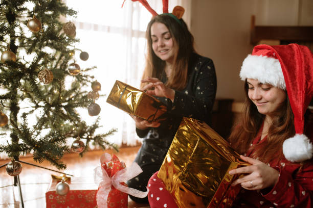 istock Young twin sisters opening christmas presents 1282353766