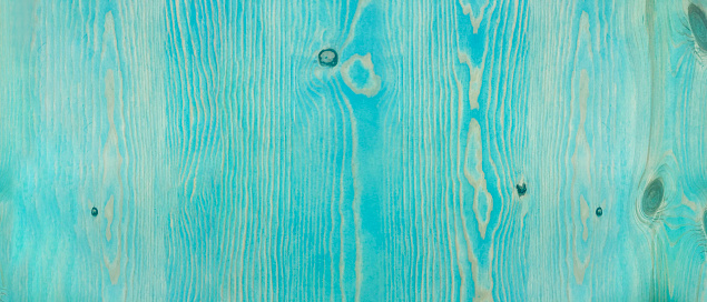 Vintage Blue Old Rustic Weathered Knotted Wood Grain Background Texture. Close Up of Wooden Plank Stained in Teal Green Beach Sea Color. Horizontal with Copy Space.