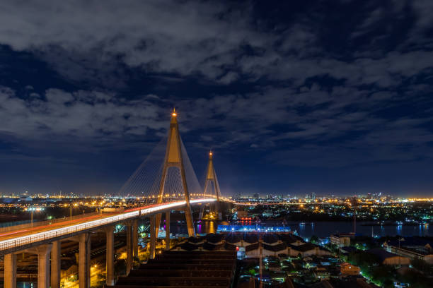 istock Large suspension bridge over Chao Phraya river with traffic at night 1282355566