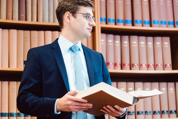 istock Lawyer in his office reading precedents in thick books 1282357622