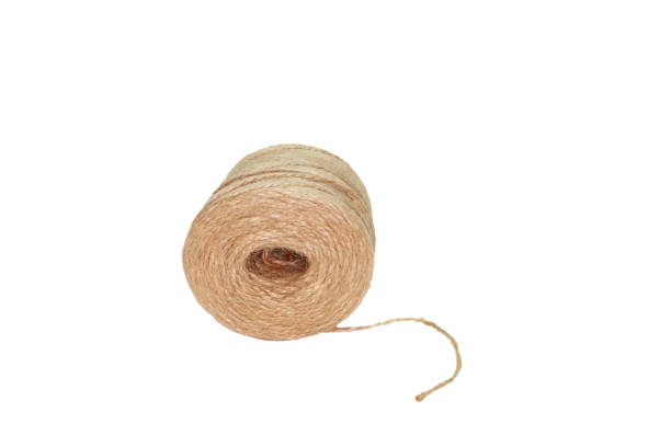 istock spool of thread beige on white background, isolated 1282358494