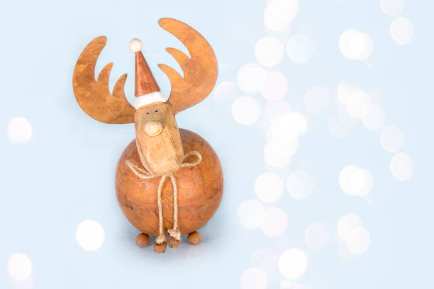 Christmas bauble deer on shiny blue background. Happy New Year celebration
