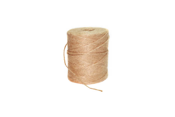 istock spool of thread beige on white background, isolated 1282358900