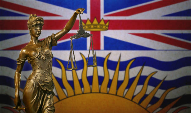 Lady Justice before a flag of British Columbia