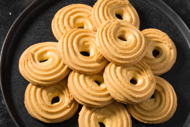 istock Cookies on a black ceramic plate on a black kitchen table. The view from the top 1282359993