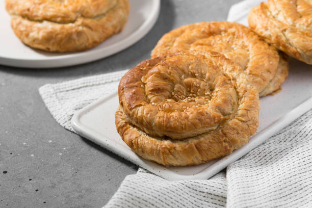 istock Buns on a wooden Board Board on a light gray kitchen table 1282360148