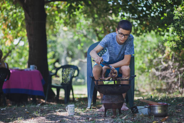 istock Extended family enjoying in the backyard preparing barbecue 1282360470