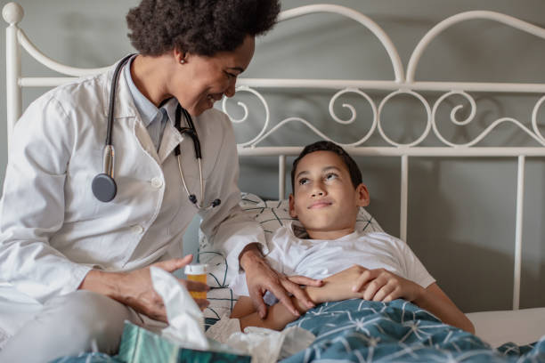 istock Doctor at home checking for a sick little boy 1282361371