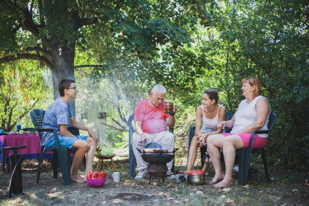 istock Extended family enjoying in the backyard preparing barbecue 1282361599
