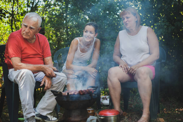 istock Extended family enjoying in the backyard preparing barbecue 1282362329