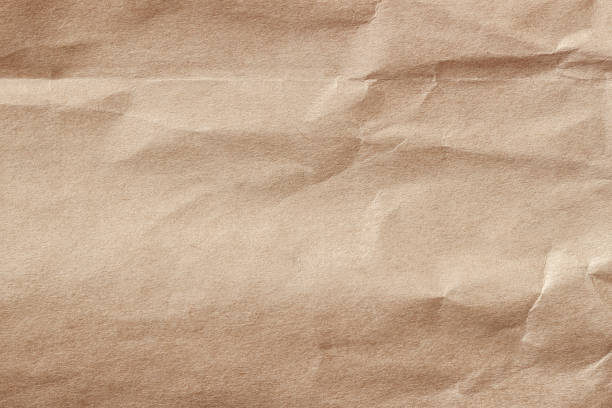 istock Wrinkled paper. Recyclable material, texture, vintage cardboard, background 1282362559