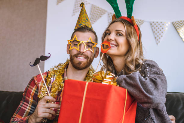 istock Couple celebrating Christmas at home and having  fun 1282364253