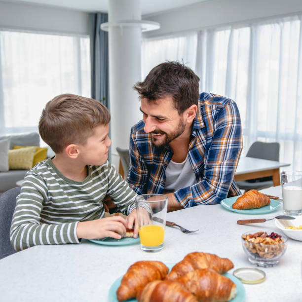 istock Little boy and his father having breakfast together 1282364965