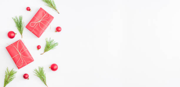 istock Flat lay border with red christmas decoration, pine branches on a white background 1282365001