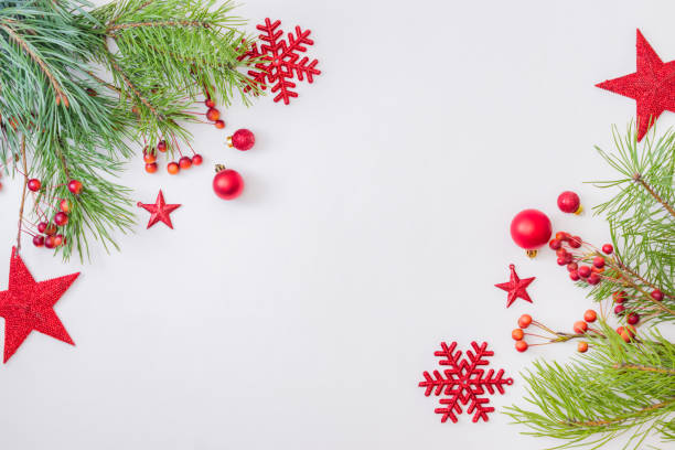 istock Flat lay frame with red christmas decoration, pine branches on a white background 1282365020