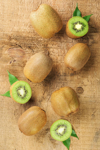 istock Fresh kiwi on a rough wooden background. Top view 1282366506