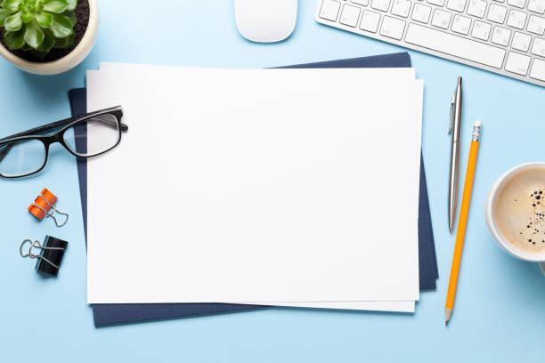 istock Office table with blank paper, supplies and computer 1282367498