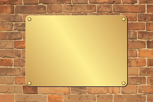 golden plaque on brick wall