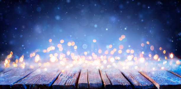 Snowy Wooden Table With Defocused Lights - Abstract Christmas Background