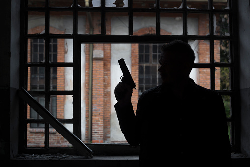 Photo is taken with full frame dslr camera inside of some dark abandoned building, in front of broken window. Actor performance.