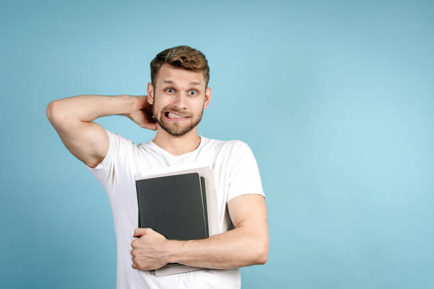 istock Adult student guy standing with copybooks in hand 1282373269